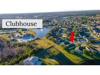 A beautiful aerial view of the neighborhood with a lake and community clubhouse at 2132 Darlin Cir, Orlando, FL 32820