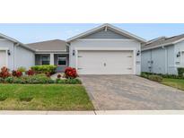 Attractive single-story home with a two-car garage and landscaped front yard at 3013 Cherry Blossom Loop, St Cloud, FL 34771