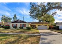 Charming ranch home with mature landscaping and a large tree in the front yard at 3817 Bainbridge Ave, Orlando, FL 32839