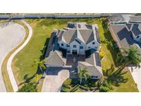Stunning aerial view of a two-story home with a large front yard, water fountain, and manicured landscaping at 14039 Hampshire Bay Cir, Winter Garden, FL 34787