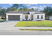 New construction home with a modern design and two-car garage at 162 Nw 42Nd Pl, Ocala, FL 34475