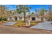 Attractive single-story home with landscaped yard and circular driveway at 2397 River Tree Cir, Sanford, FL 32771