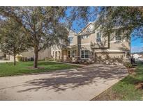 Two-story house with stone accents and a landscaped lawn at 264 Wallrock Ct, Ocoee, FL 34761