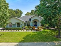 Beautiful home with a well-manicured lawn and a large driveway at 4938 Raylene Way, St Cloud, FL 34771