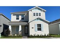 Charming two-story home with white facade, light blue accents, and a well-maintained front yard at 5374 Lake Virginia St, Winter Garden, FL 34787