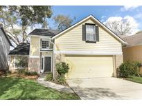 Charming two-story home with a well-maintained lawn and a two-car garage at 1369 Black Willow Trl, Altamonte Springs, FL 32714