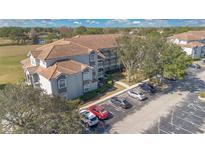 Exterior view of condo building with parking and landscaping at 13839 Fairway Island Dr # 1122, Orlando, FL 32837