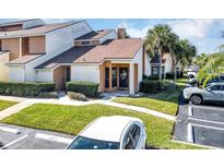 Charming townhome featuring well-maintained landscaping and a designated parking spot in a quiet community at 3002 Clubview Dr, Orlando, FL 32822