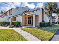 Charming townhome featuring a well-manicured lawn, walkway and a inviting front entrance at 3002 Clubview Dr, Orlando, FL 32822