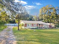 Ranch-style home with mature landscaping and a spacious yard at 5240 N Powers Dr, Orlando, FL 32818