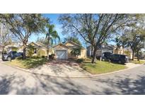 Cute yellow house with a white garage door and nicely landscaped yard at 1138 Mariner Cay Dr, Haines City, FL 33844