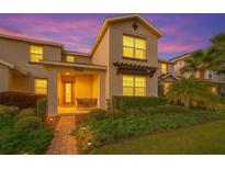 Charming home showcasing manicured landscaping, a brick walkway, and a welcoming front porch area for relaxing at 11526 Comic Aly, Orlando, FL 32832