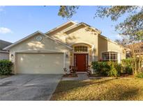 Beautiful one-story home with a two-car garage and well-manicured lawn at 13013 Quail Ct, Orlando, FL 32828