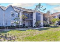 Exterior of a light blue two-story building with balconies and landscaping at 3756 Idlebrook Cir # 206, Casselberry, FL 32707