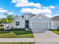 Charming single-story home with a well-manicured lawn and lush landscaping at 558 Pawnee Ct, Haines City, FL 33844