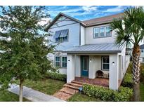 Two-story house with gray siding, metal roof, and a welcoming front porch at 9062 Sperry St, Orlando, FL 32827