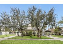 House exterior with large trees, driveway, and carport at 1209 W 6Th St, Sanford, FL 32771