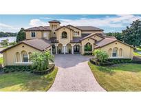 Two-story house with tile roof, large driveway, and landscaping at 12812 Jacob Grace Ct, Windermere, FL 34786