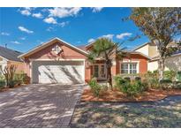 Single-story home with two-car garage and well-manicured landscaping at 140 Gladesdown Ct, Deland, FL 32724