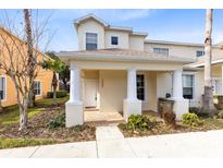 Two-story townhome with front porch and landscaping at 1407 Retreat Cir, Clermont, FL 34714