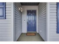 Inviting front entrance with a blue door and welcome mat at 313 Dirksen Dr # B16, Debary, FL 32713