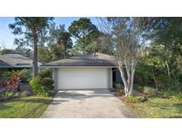 Cute and cozy one-story home with a single car garage and well-manicured landscaping at 360 Gleneagles Dr, New Smyrna Beach, FL 32168