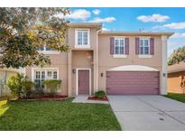 Two-story house with purple accents and a landscaped lawn at 131 Bristol Forest Trl, Sanford, FL 32771