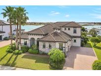 Two-story home with tile roof, stone accents, and landscaping at 15550 Avenue Of The Arbors, Winter Garden, FL 34787