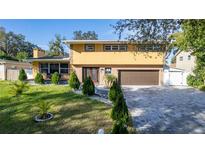 Two-story house with a landscaped yard and a paved driveway at 5006 Monet Ave, Belle Isle, FL 32812