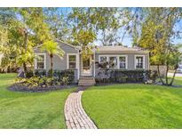 Charming bungalow with brick pathway, lush landscaping, and a well-maintained lawn at 1442 W Yale St, Orlando, FL 32804