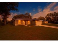 Charming single-story home with a well-manicured lawn and an inviting entrance at 15322 Sw 50Th Court Rd, Ocala, FL 34473