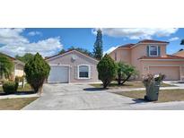 Two-story home with a one-car garage and landscaped yard at 2317 Santa Lucia St, Kissimmee, FL 34743