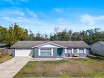 Ranch style home with attached garage and well-manicured lawn at 41 Apple Hill Holw, Casselberry, FL 32707