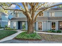 Charming light blue townhome with a large oak tree in the front at 421 Sheoah Blvd # 5, Winter Springs, FL 32708