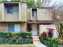 Tan two-story townhome with manicured landscaping and walkway at 473 Oak Haven Dr # 473, Altamonte Springs, FL 32701
