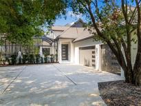 Modern home with attached two-car garage and lush landscaping at 9697 Bryanston Dr, Orlando, FL 32827
