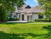 Beautiful two-story home featuring a well-manicured lawn, neutral paint, a black front door, and an attached two-car garage at 9697 Bryanston Dr, Orlando, FL 32827