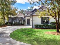 Beautiful single-story home with manicured lawn and a screened-in pool area in the back at 9697 Bryanston Dr, Orlando, FL 32827