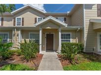 Inviting exterior of a two-story townhome with a walkway and landscaping at 5356 Diplomat Ct # 107, Kissimmee, FL 34746