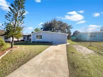 Nice curb appeal with a gray house and a well-maintained lawn at 211 Palm Pl, Sanford, FL 32773