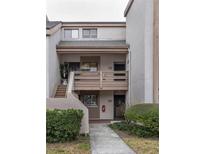 Exterior view of a two-story condo building with a walkway and landscaping at 246 Orienta Point St # 246, Altamonte Springs, FL 32701