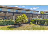 Private screened patio with lush landscaping and fenced yard at 4587 Terrasonesta Dr, Davenport, FL 33837