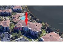 Aerial view of condo building with pool and surrounding landscape at 5012 Shoreway Loop # 30307, Orlando, FL 32819