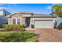 Inviting curb appeal with stone accents and a two-car garage at 568 Seattle Slew Dr, Davenport, FL 33837