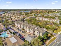 Spacious neighborhood featuring townhomes, lush landscaping, a community pool, and nearby lake at 6413 Astor Village Ave # 313, Orlando, FL 32835