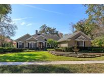 Charming single-story home featuring well-manicured landscaping, green lawn, and an elegant fountain at 812 Edgeforest Ter, Sanford, FL 32771