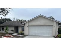 One-story house with attached garage, freshly painted exterior, and landscaped front yard at 9142 Sabal Palm Cir, Windermere, FL 34786