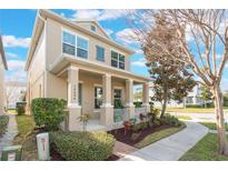 Two-story house with front porch, landscaping, and a light beige exterior at 14694 Seton Creek Blvd, Winter Garden, FL 34787