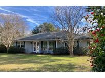 Charming one-story home with a well-maintained lawn and mature trees at 1821 Stanley St, Longwood, FL 32750