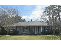 Charming ranch home with a covered porch and well-maintained lawn at 1821 Stanley St, Longwood, FL 32750